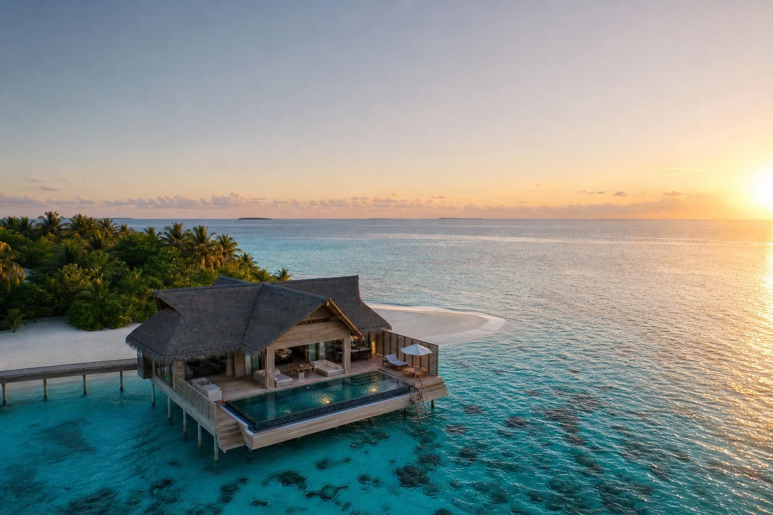 Private overwater villa on an Indian Ocean atoll at golden hour